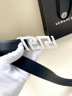 Leather belt with silver-tone geometric buckle on dark blue strap