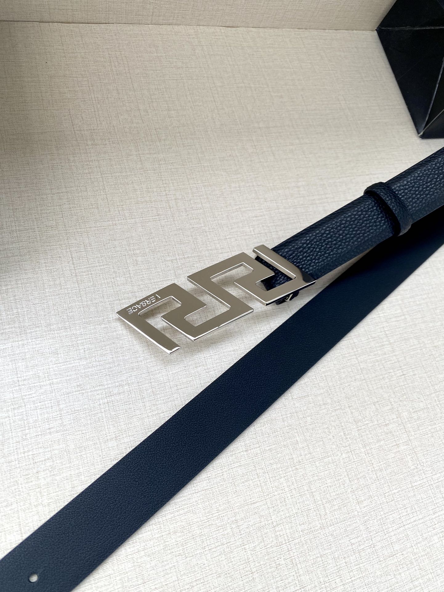 Dark blue leather belt with silver-tone rectangular buckle plate