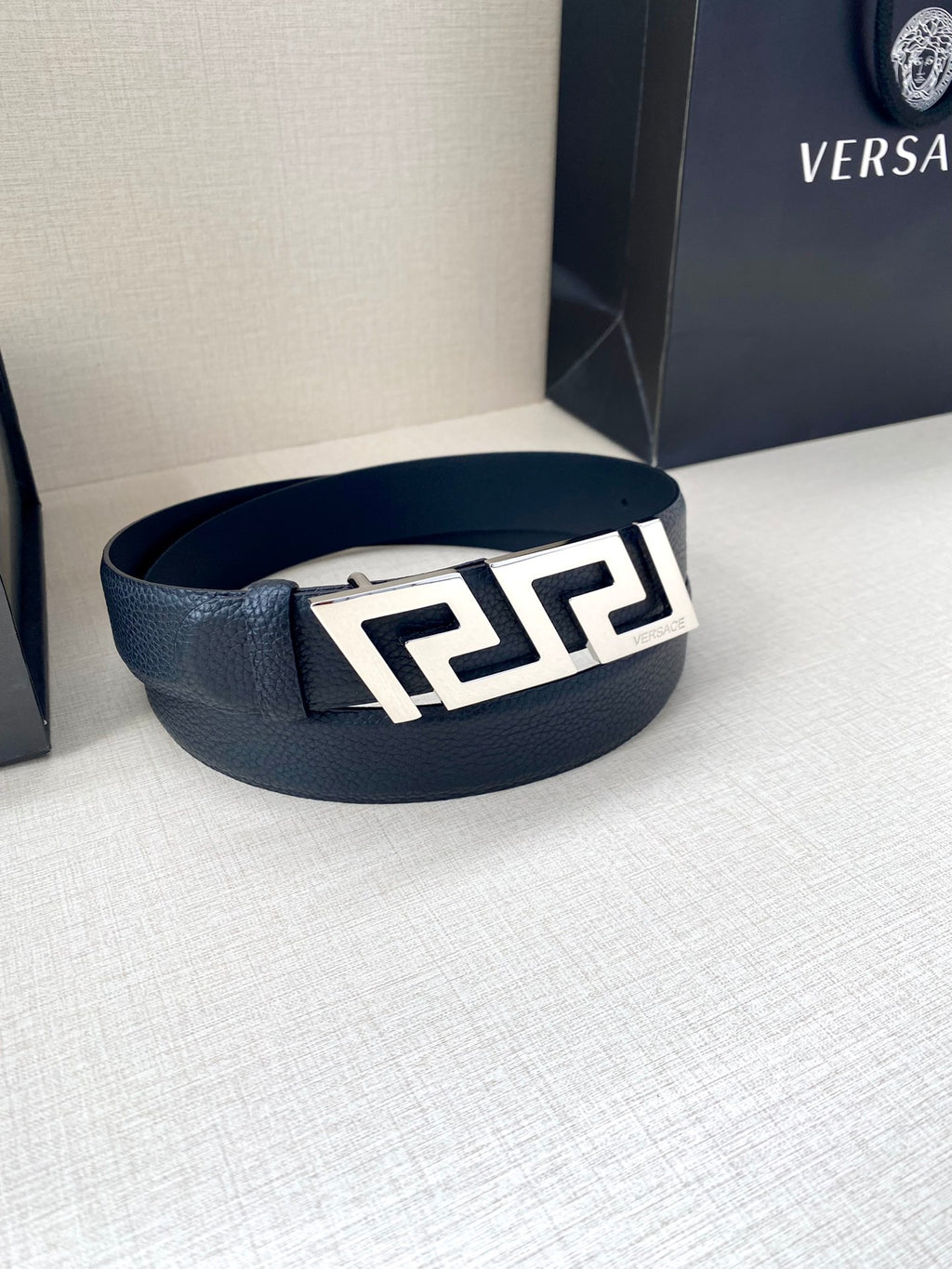 Dark blue leather belt with silver-tone geometric buckle