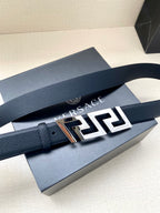 Dark blue leather belt with gold-tone and black Greek-key style buckle
