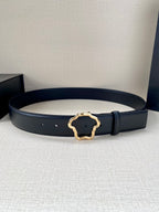Dark leather belt with gold-tone ornate buckle, laid flat