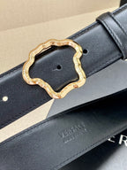 Dark leather belt with gold-tone ornate buckle and embossed branding
