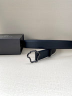 Black leather belt with silver-toned ornate buckle, side view