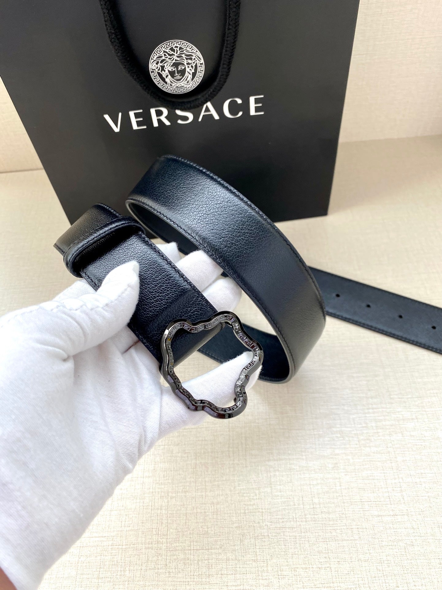 Dark blue leather belt with silver-tone buckle and adjustable punched holes