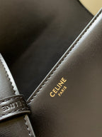 Celine leather bag close-up showing printed text at strap attachment
