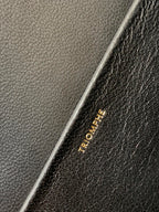Celine leather bag close-up of gold stamped text near seam
