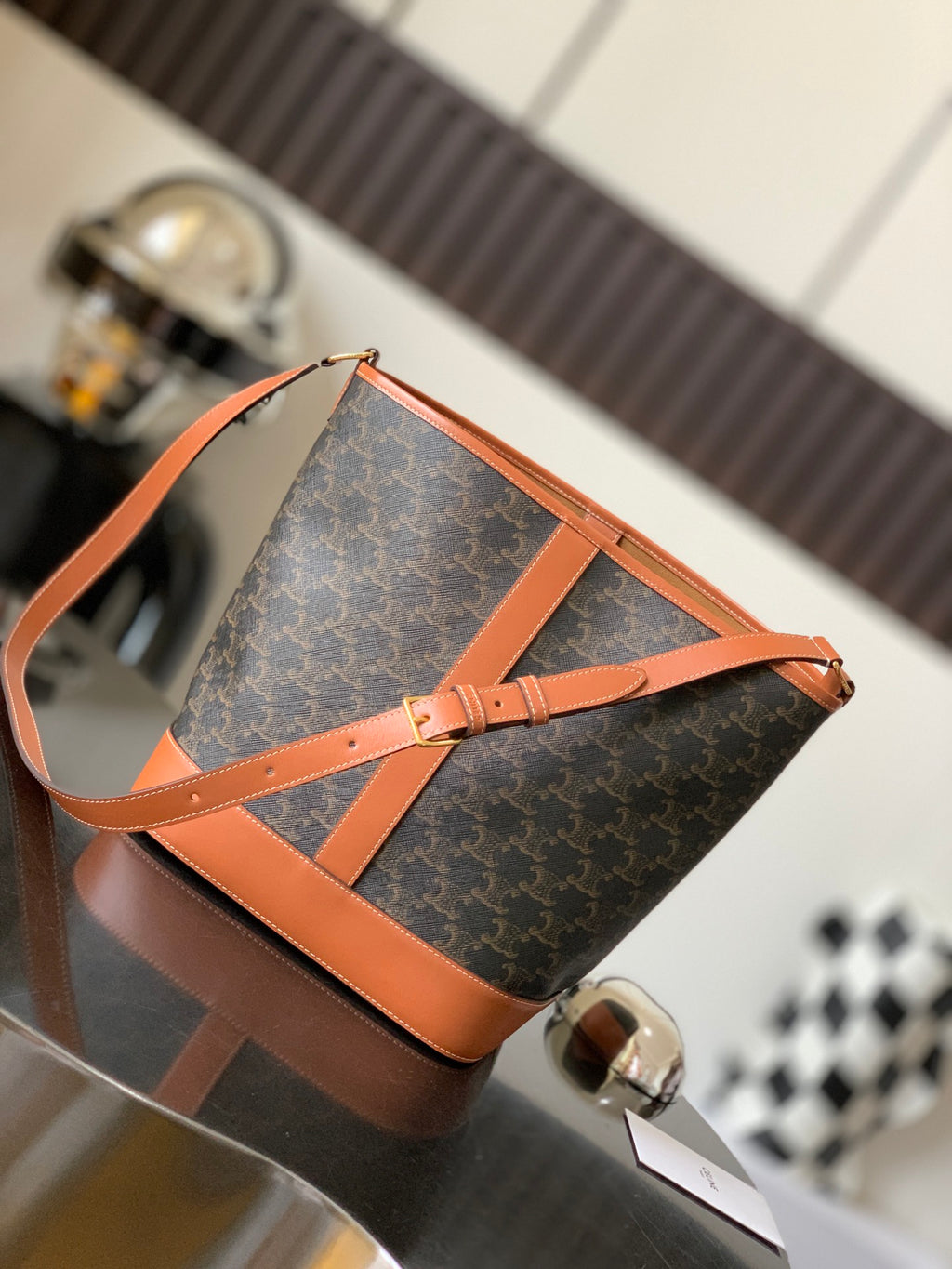 Celine bag in dark monogram canvas with tan leather strap and top handles, zip