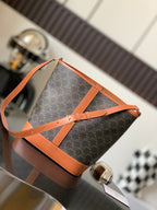 Celine bag in dark monogram canvas with tan leather strap and top handles, zip