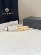 White leather belt with gold-tone FF buckle and stitched end, laid flat