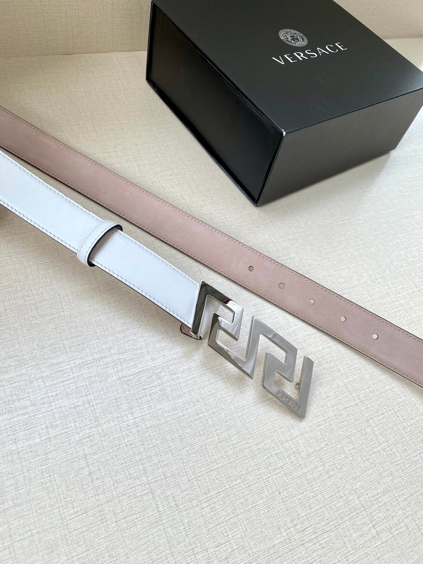 White leather belt with light pink underside and silver-tone FF buckle