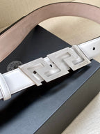 White leather belt close-up with silver-tone FF buckle and logo plate