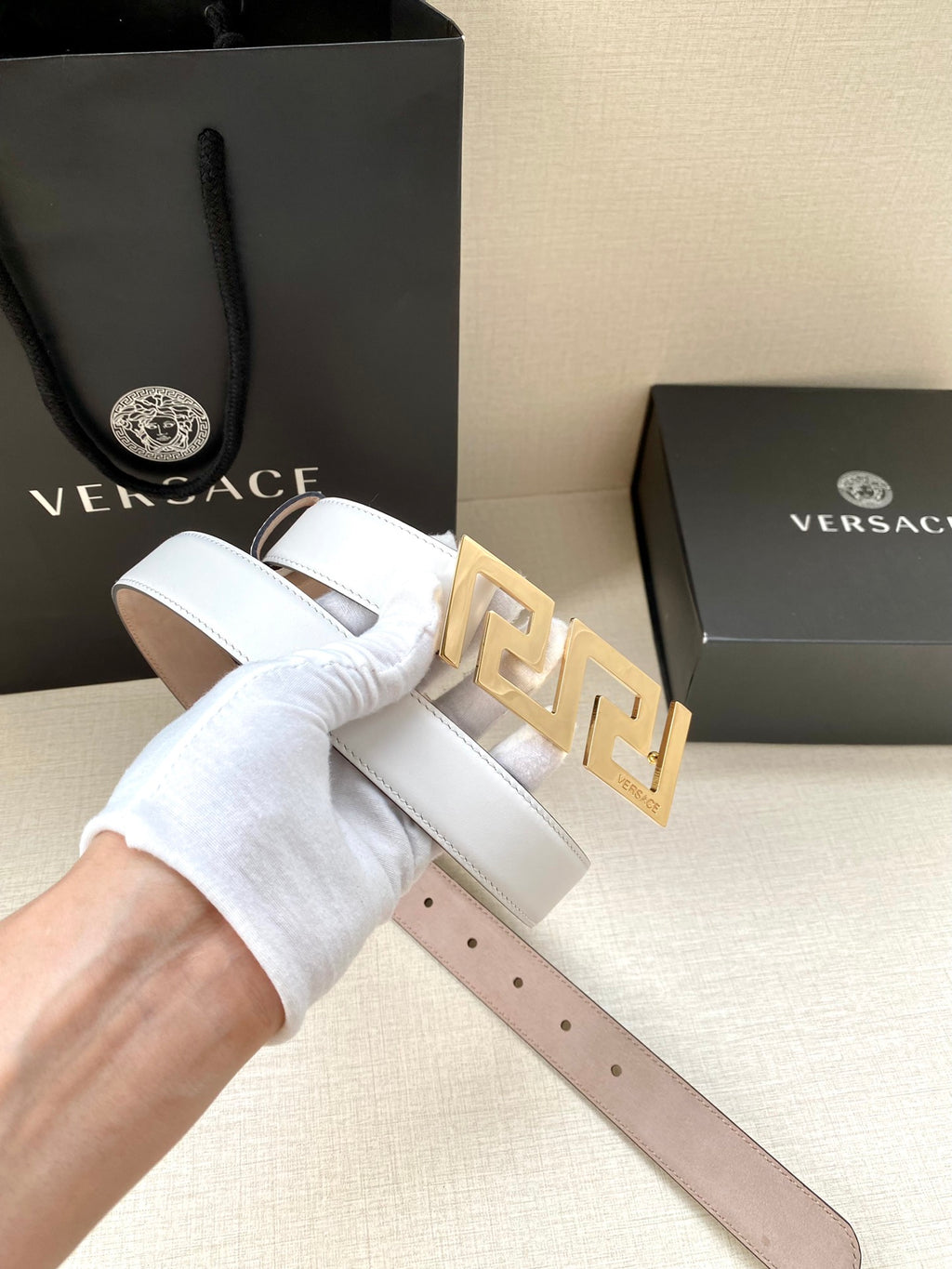 White leather belt with gold-tone FF buckle and punched adjustment holes