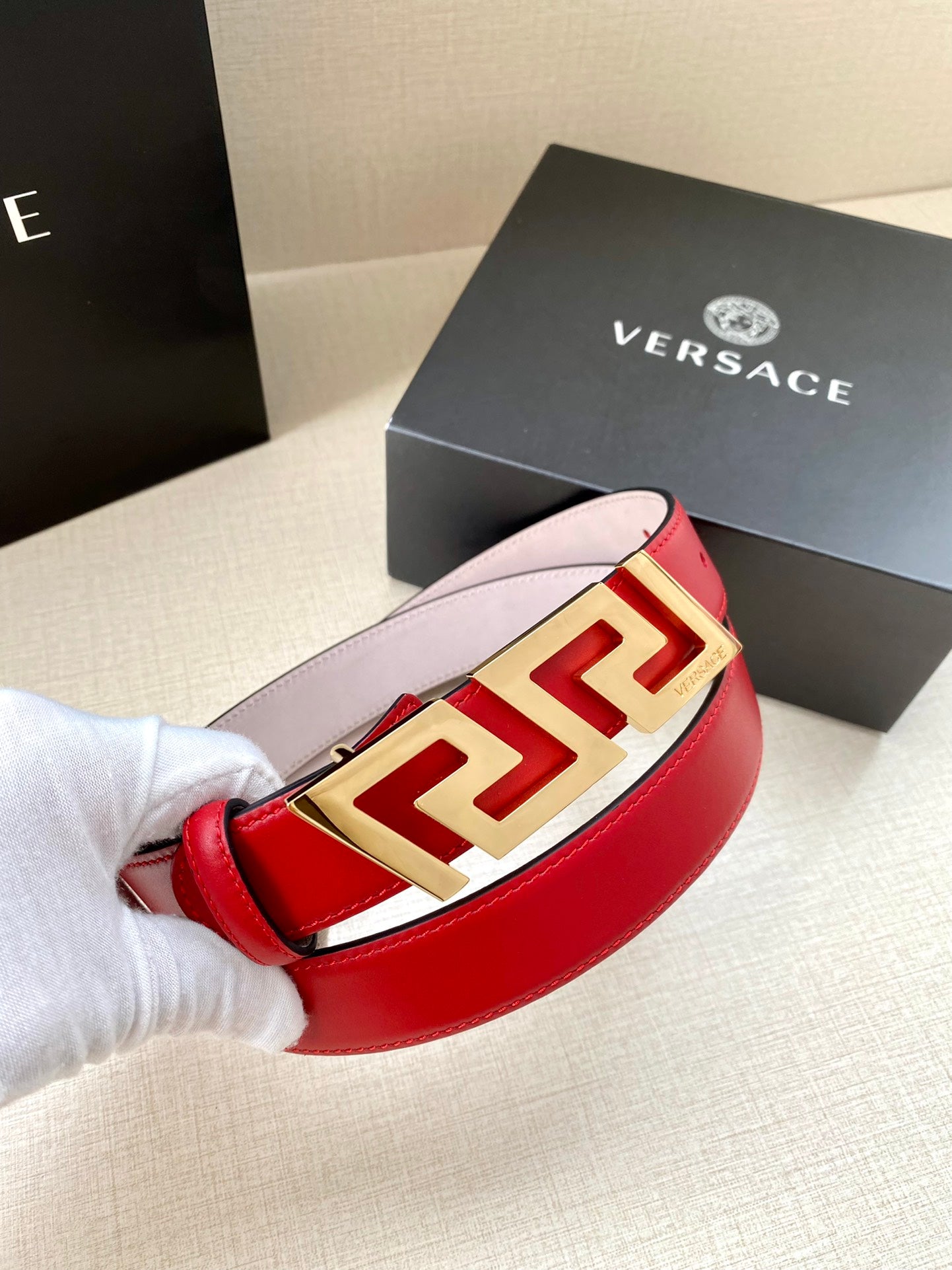 Versace belt with red leather strap and gold Greek-key buckle front detail