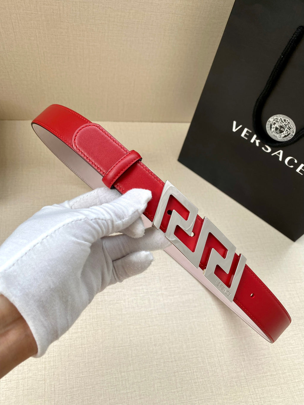 Versace belt in red leather with silver Greek-key buckle and prong keeper detail