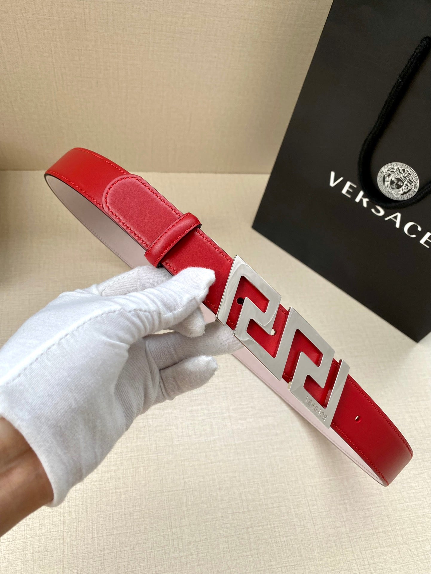 Versace belt in red leather with silver Greek-key buckle and prong keeper detail