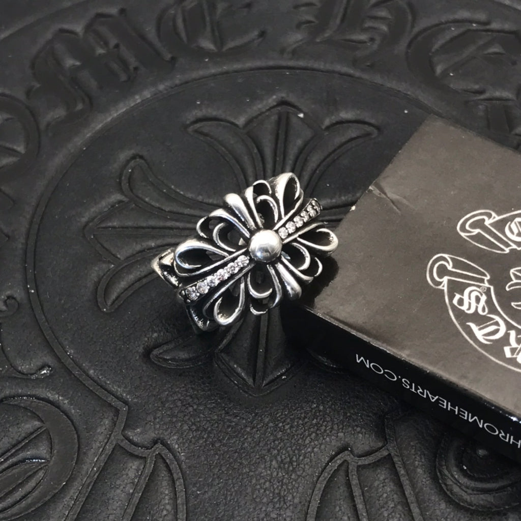 Filigree flower ring with round center bead, silver-tone metal.