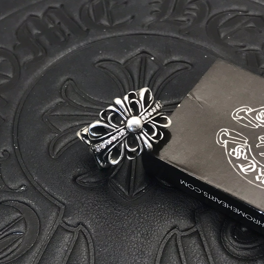 Filigree flower ring with round center bead, silver-tone metal.