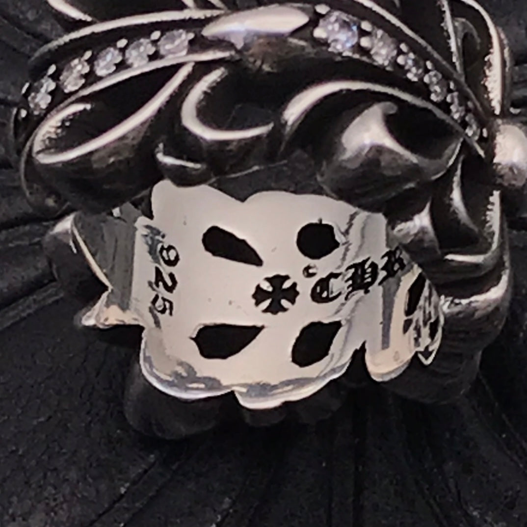 Engraved inner ring band with numbers and floral marks, silver-tone.