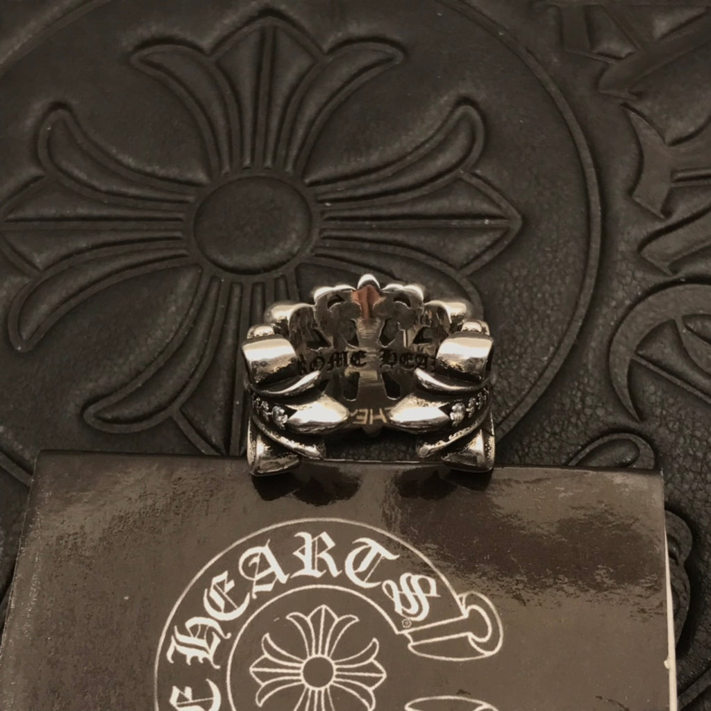 Chunky silver-tone ring with ornate floral centerpiece and raised petals.