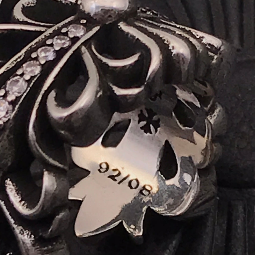 Close-up of engraved inner ring band with floral icons and numbers.