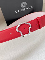 Red leather belt with silver-toned Medusa-style buckle and circular holes