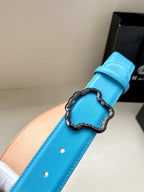 Blue leather belt close-up: buckle set on strap with two punched holes.