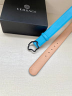 Blue leather belt with center buckle; tan underside visible and stitched edge.