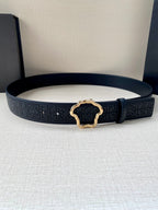 Versace belt laid flat, dark navy with logo pattern and gold-tone emblem buckle.