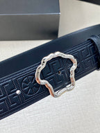 Versace belt close-up: dark navy logo embossing with ornate gold-tone buckle.