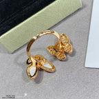 Gold butterfly ring with white opal center and clear pavé detailing