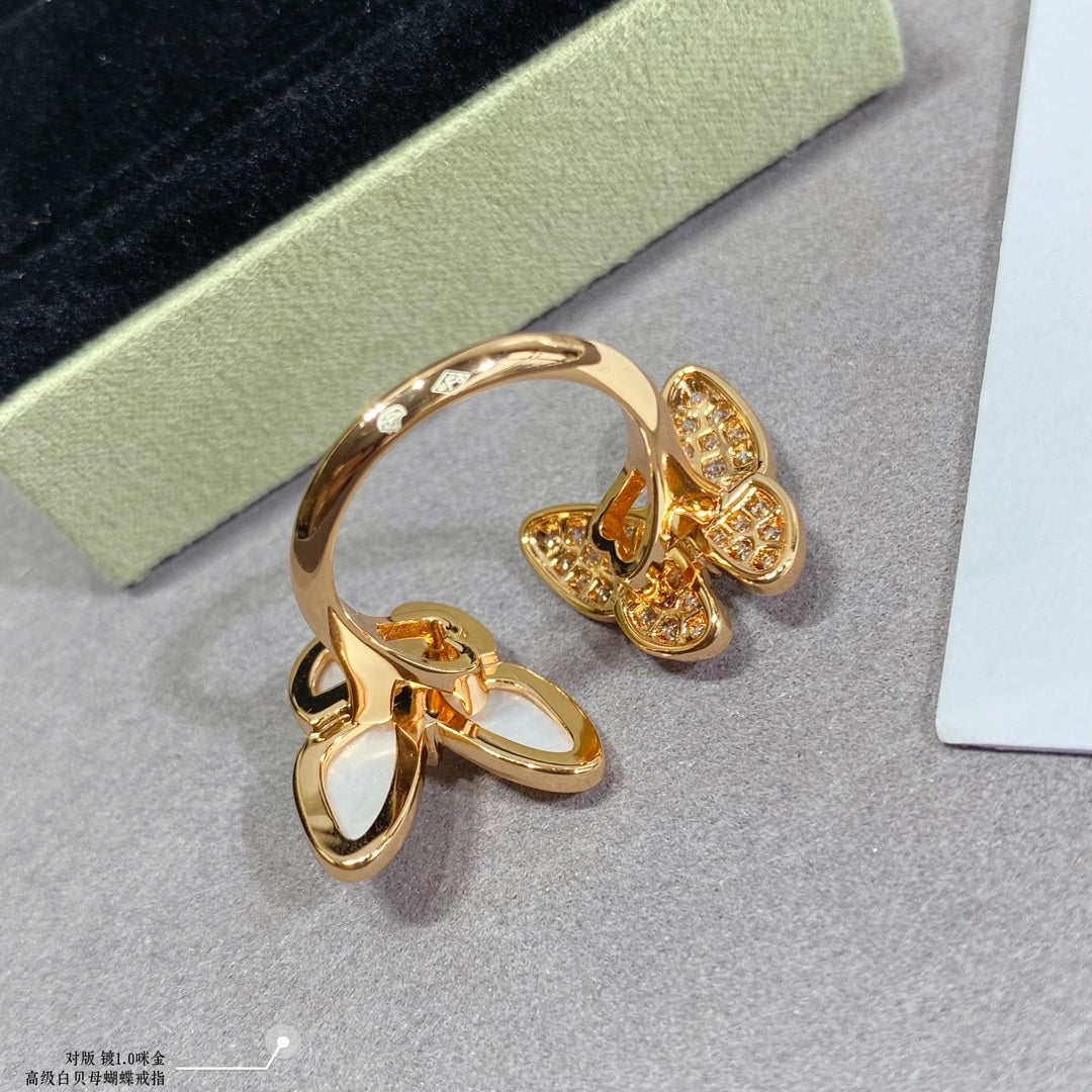 Gold butterfly ring with white opal center and clear pavé detailing