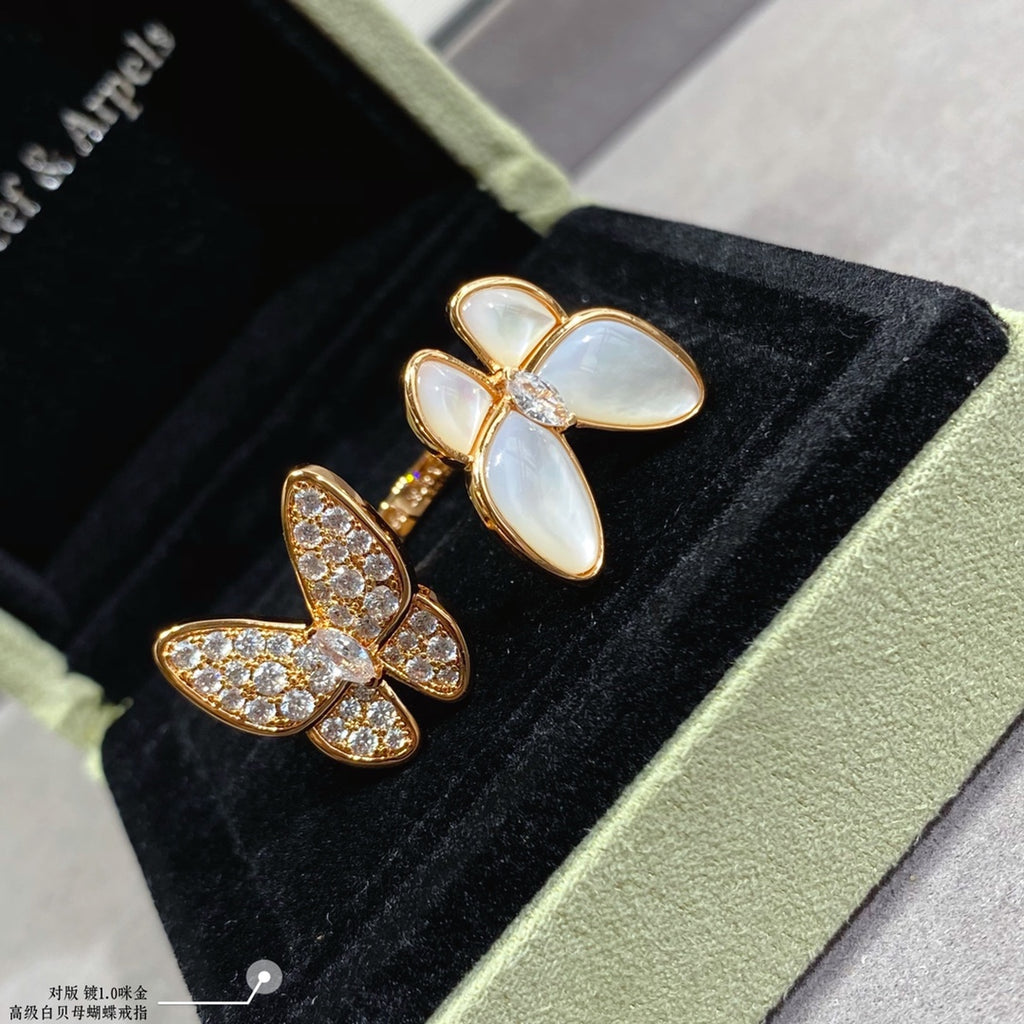 Gold butterfly earrings with white opal stones and clear pavé accents