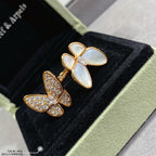 Gold butterfly earrings with white opal stones and clear pavé accents