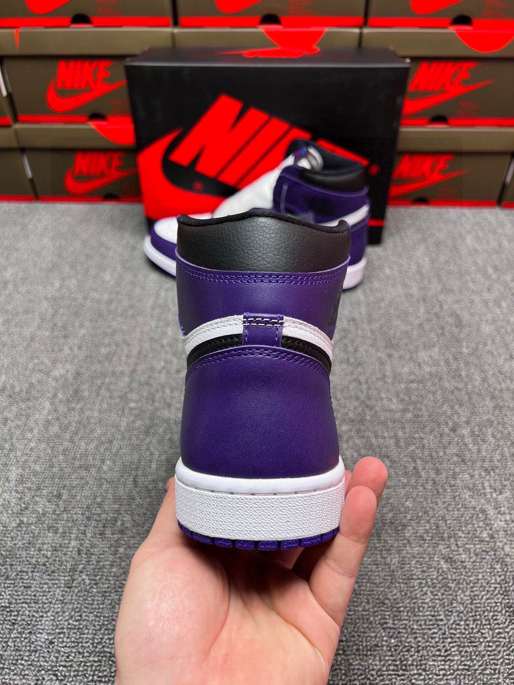 High-top sneakers rear view with purple collar, black heel trim, and white sole