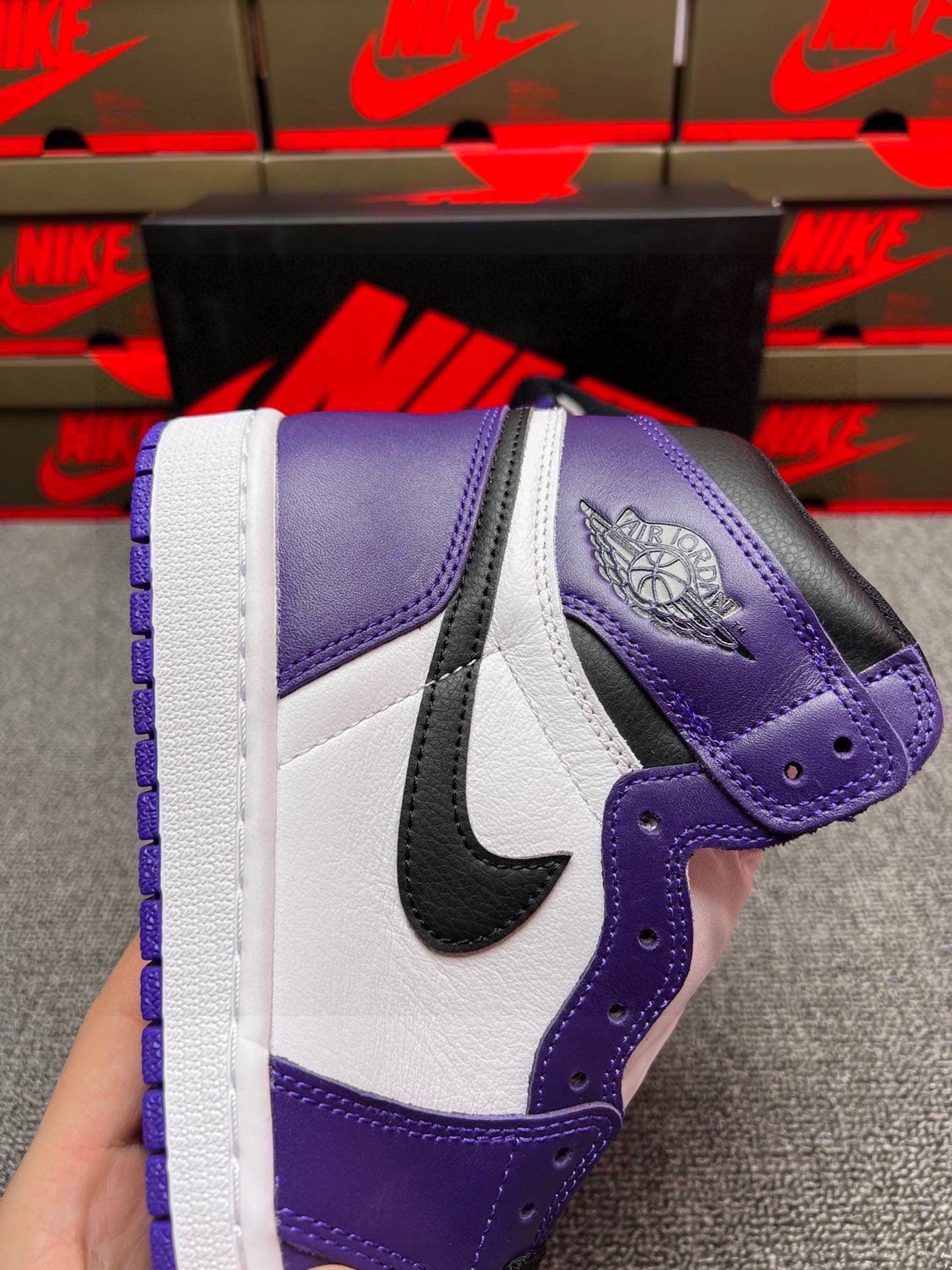 High-top sneakers with white panels, purple ankle collar, and black Nike swoosh