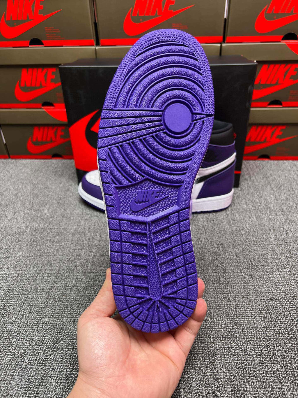 High-top sneaker outsole in purple with textured tread and circular traction detail