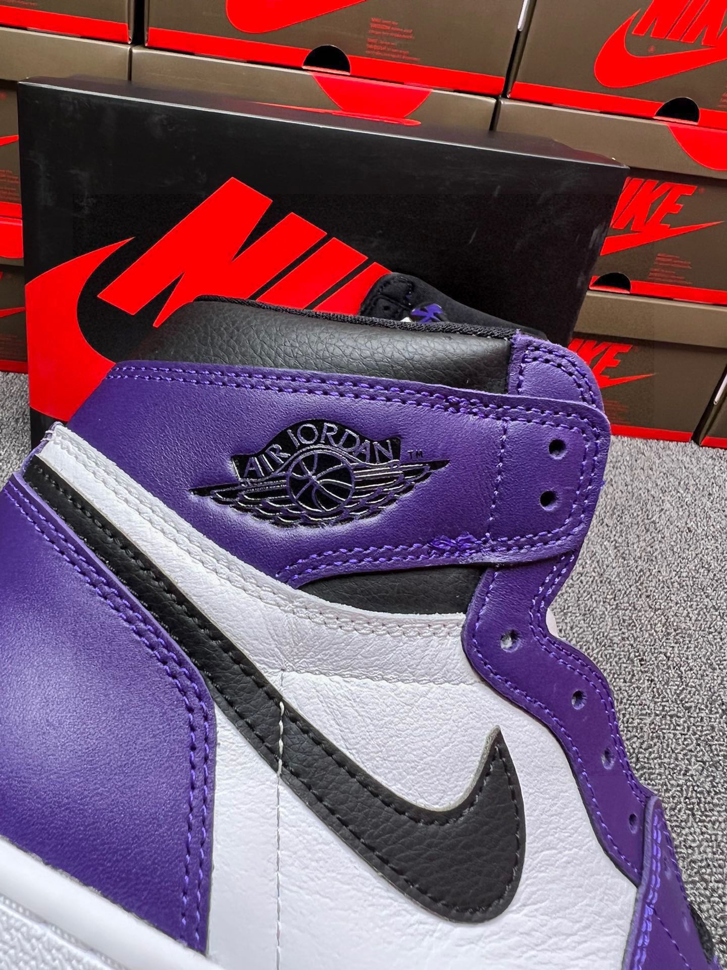 High-top sneakers heel with purple panel, white stripe, and Air Jordan logo