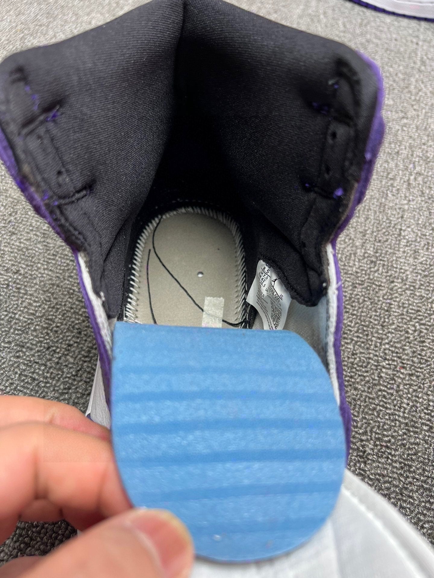 High-top sneaker interior view with blue insole and black padded collar
