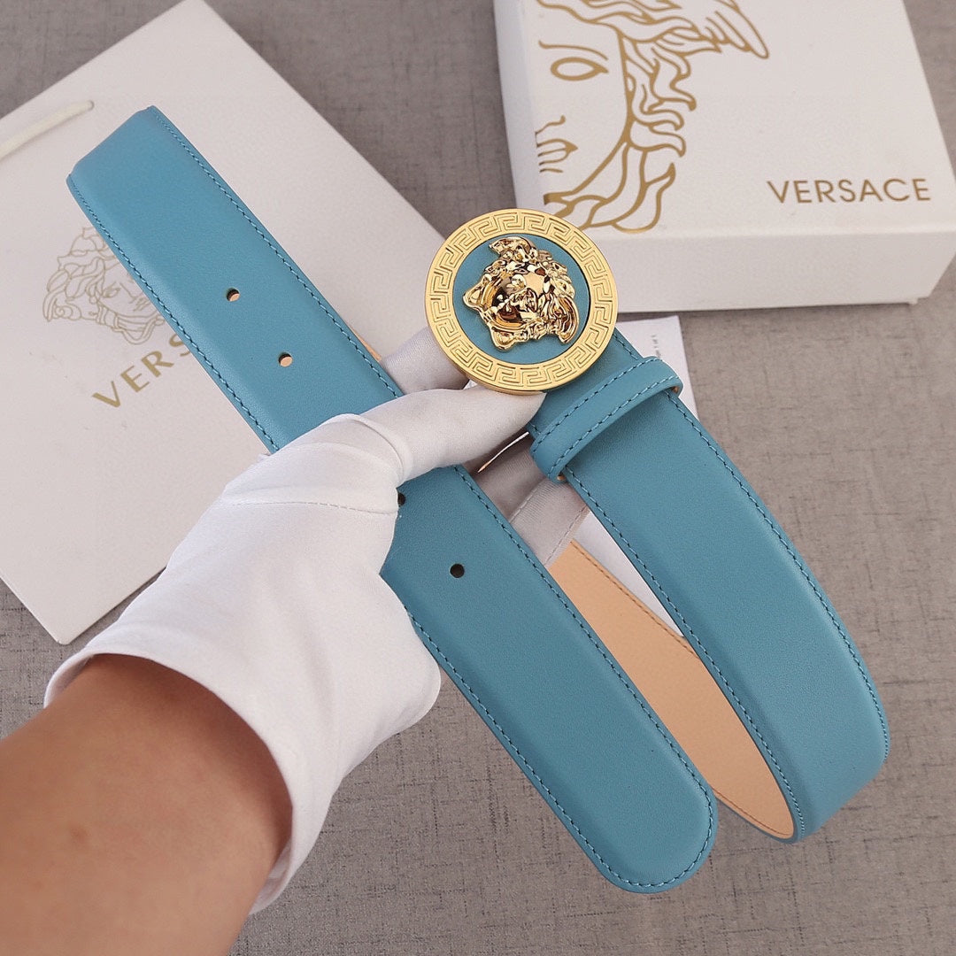 Sky blue leather belt with gold Medusa style round buckle and two strap loops