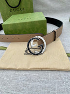 Beige leather belt with circular GG-logo buckle and keeper holes