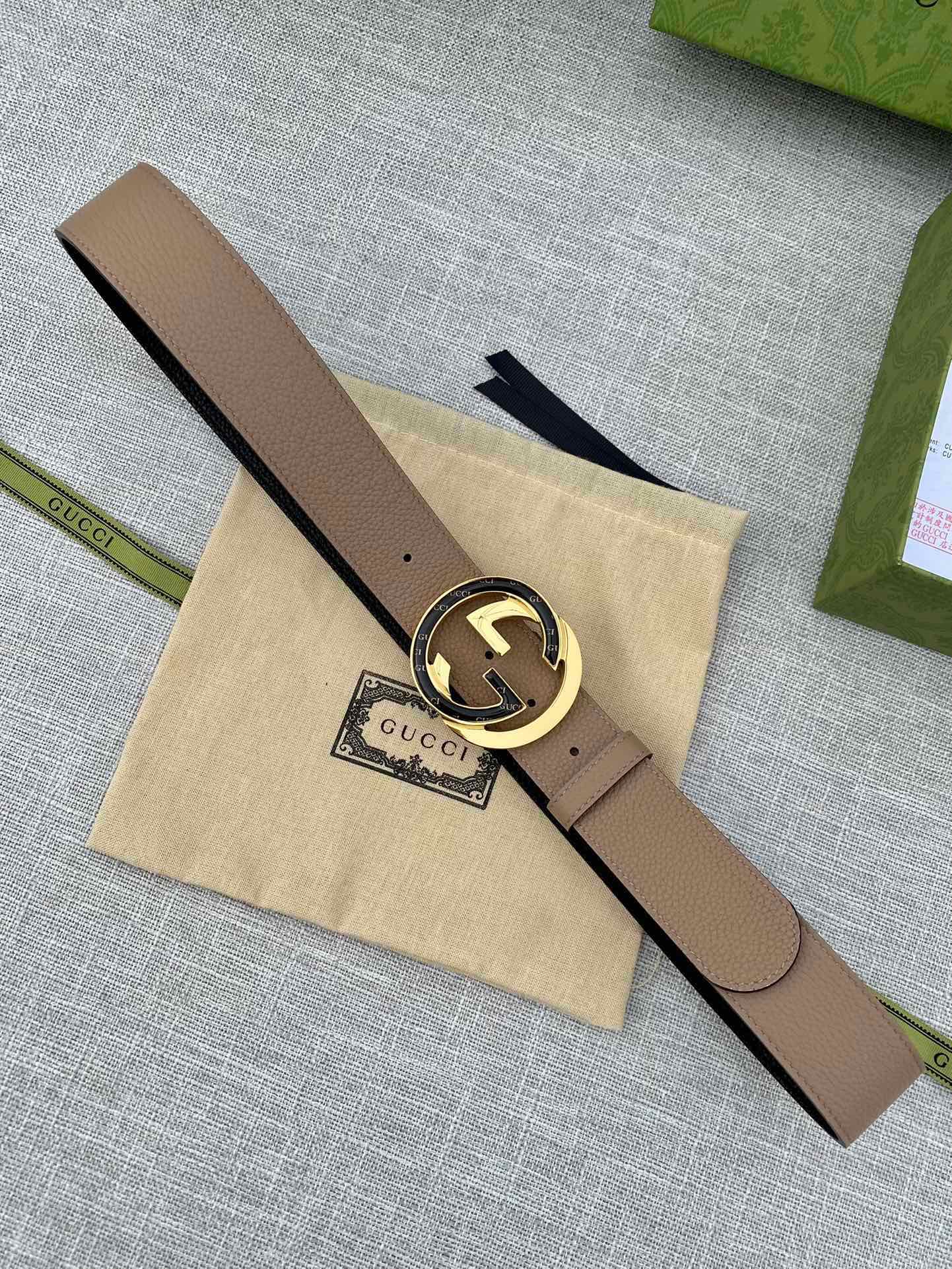Beige leather belt with gold-toned GG-logo buckle, dark belt shown nearby