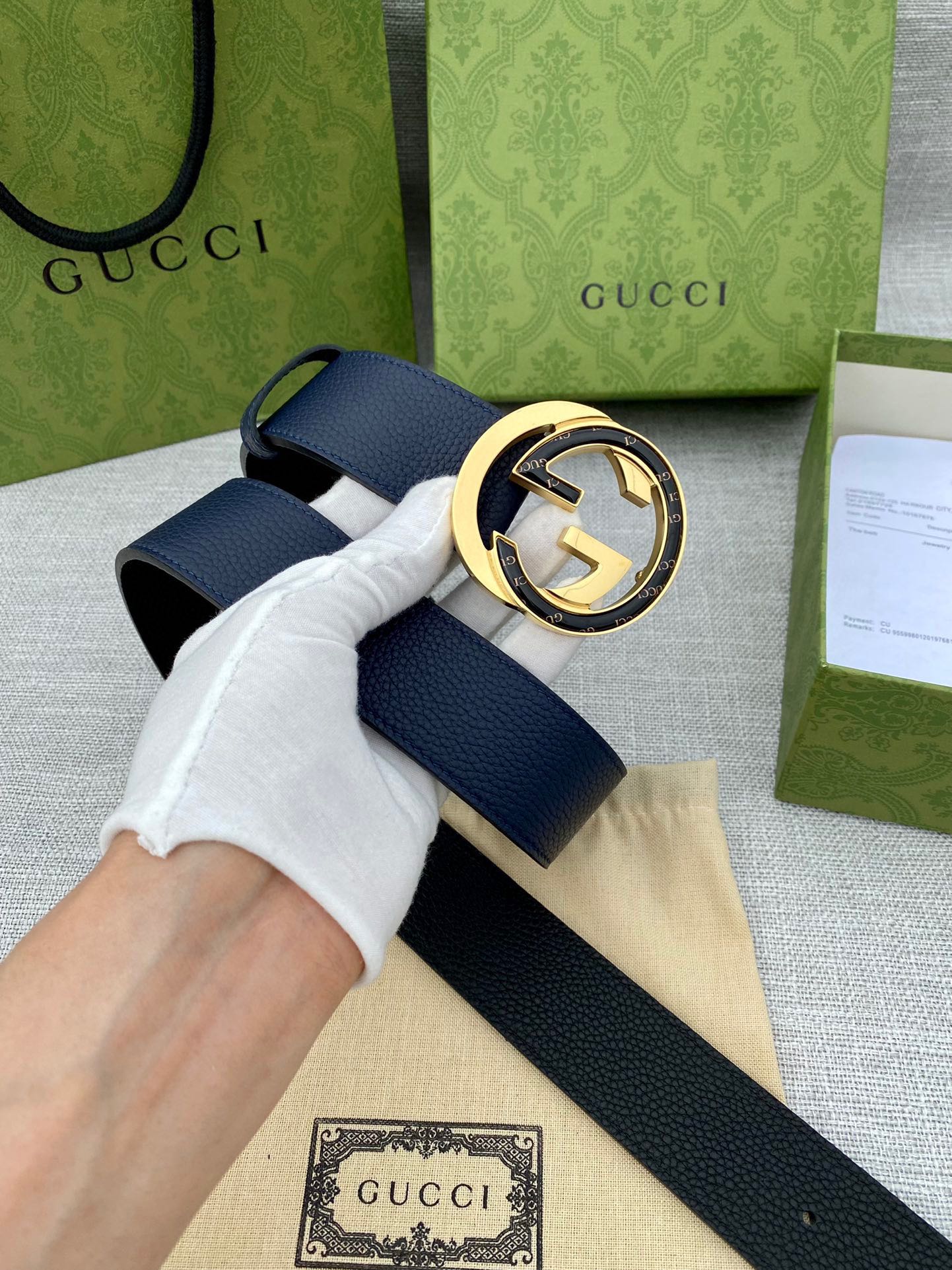 Navy leather belt with large round gold-tone GG buckle