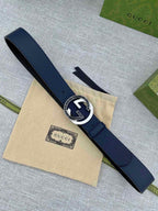 Navy leather belt with round silver-tone buckle and GG logo