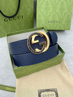Navy leather belt with circular gold-tone GG logo buckle