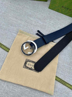 Navy leather belt with round GG logo buckle on beige pouch