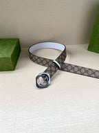 Gucci belt displayed coiled, beige-brown GG canvas strap with white edge and round interlocking G buckle