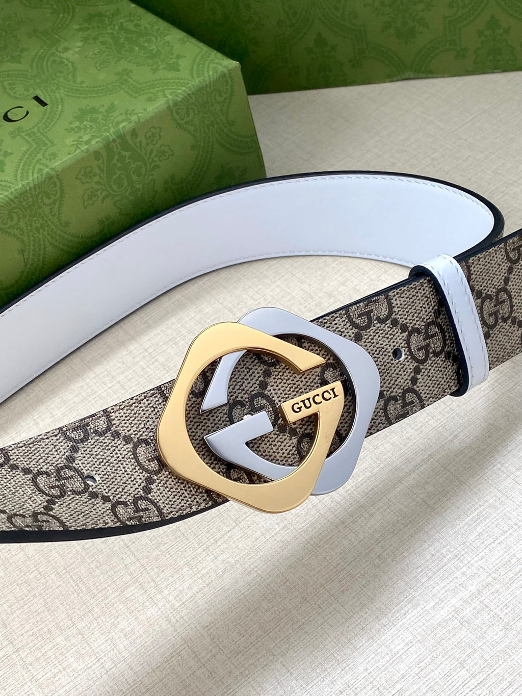 Gucci belt with blue-gray interlocking G buckle on beige-brown GG canvas strap with white lining