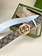 Gucci belt, GG monogram strap with round gold buckle, white leather underside