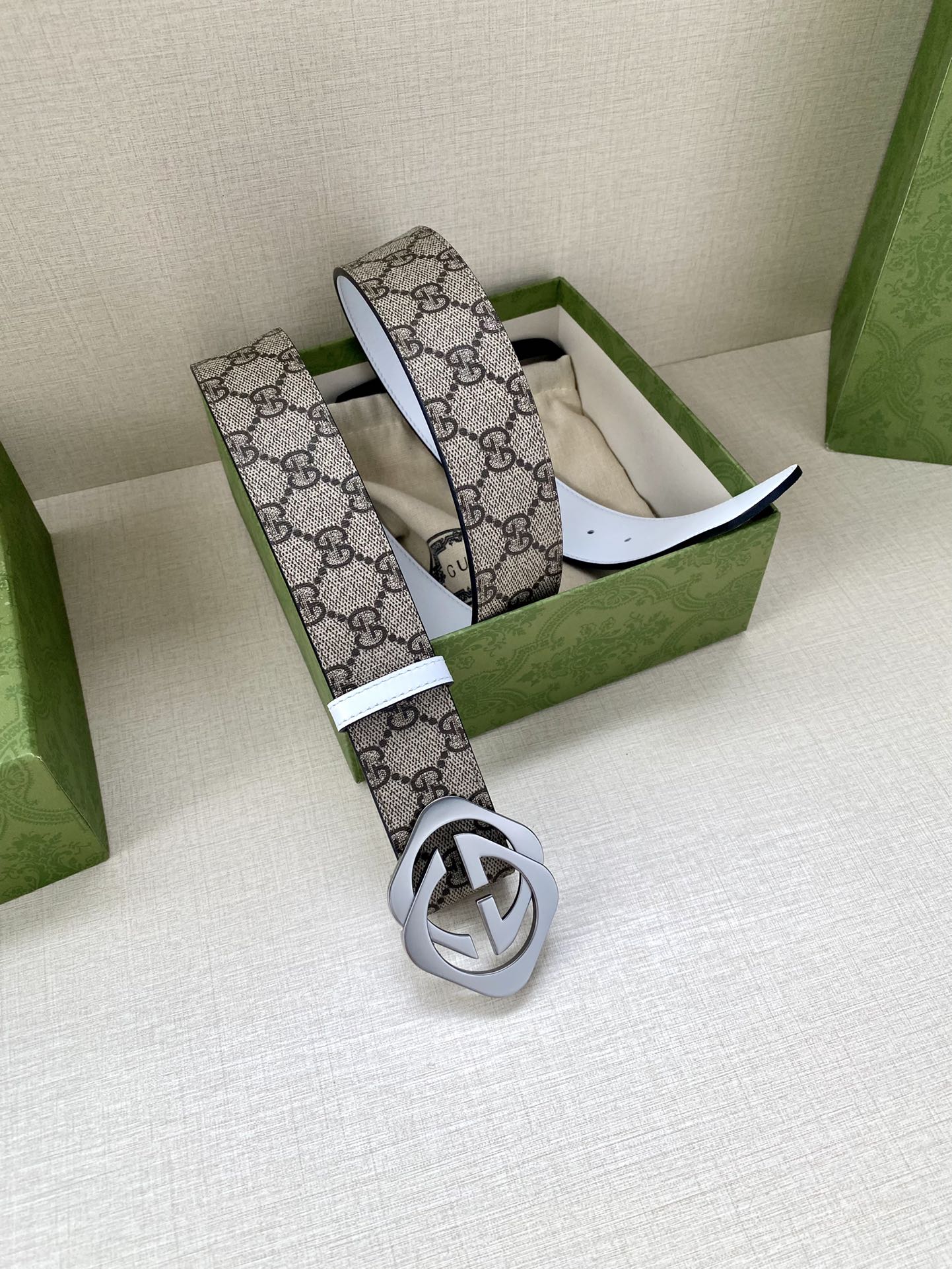 Gucci belt, GG monogram strap with white leather edges and dark metal interlocking buckle