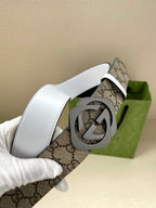 Gucci belt with white leather side and GG monogram strap, circular G buckle